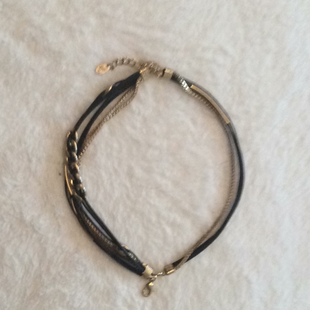 Adjustable black and gold bracelet.
